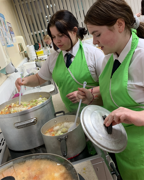 Pictured left to right is Jess and Charlotte from Year 10 busy checking that the soup is boiling nicely.